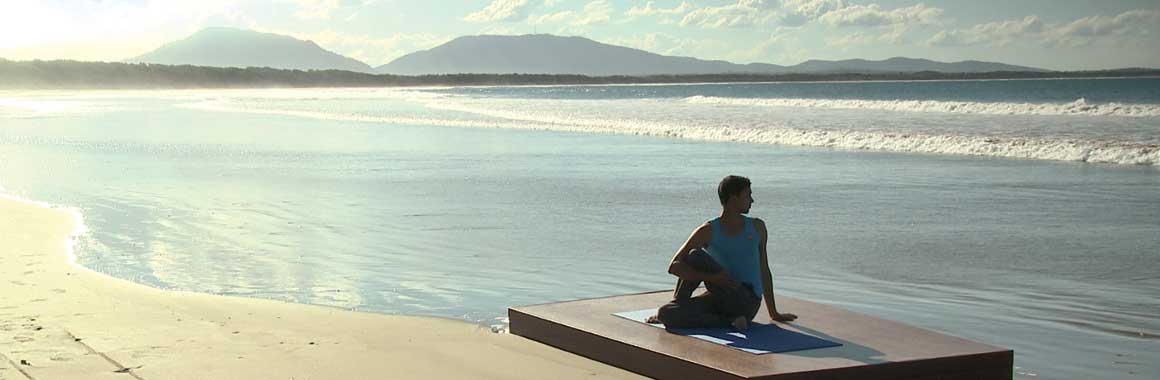 Dru yoga - sitting twist on the beach