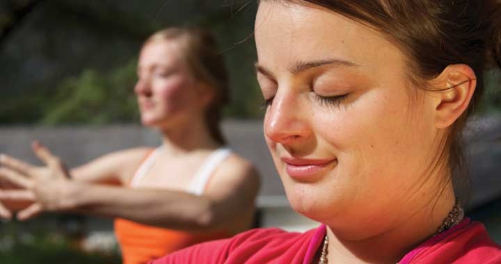 Woman peacefully contemplates during yoga