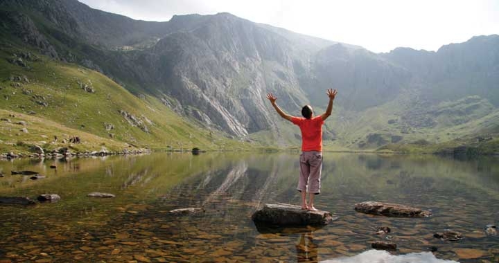 Dru Yoga teacher standing by lake
